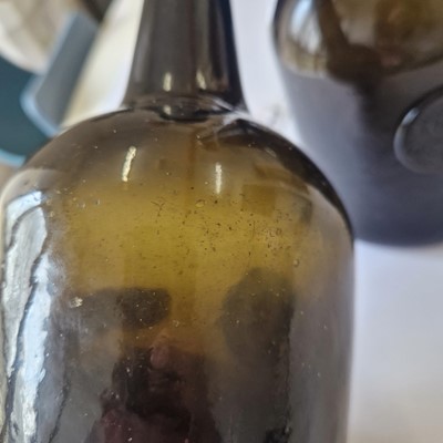 Lot 20 - A near pair of olive-green glass wine bottles