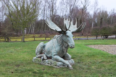 Lot 686 - A patinated metal figure of a seated moose