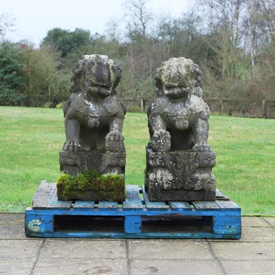 Lot 692 - A pair of black stone Buddhist lions