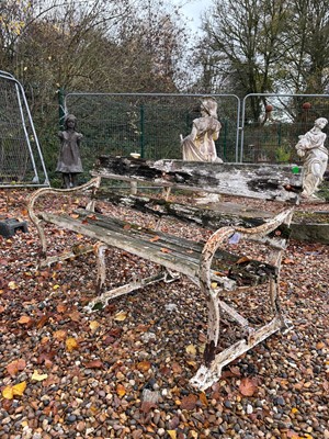 Lot 553 - A wrought iron and teak garden bench