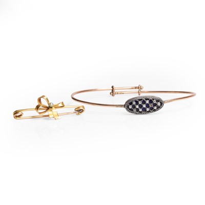 Lot 1168 - A gold seed pearl bar brooch and a paste bangle