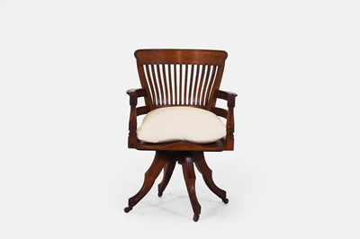 Lot 61 - A walnut revolving desk chair