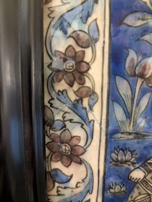 Lot 15 - A large Qajar moulded and underglaze-painted pottery figural tile