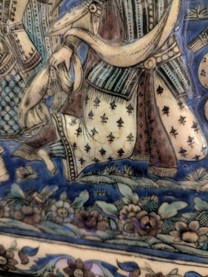 Lot 15 - A large Qajar moulded and underglaze-painted pottery figural tile