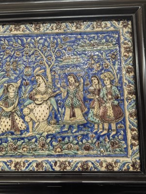 Lot 15 - A large Qajar moulded and underglaze-painted pottery figural tile