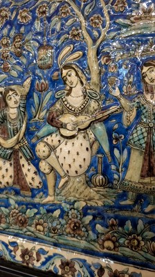Lot 15 - A large Qajar moulded and underglaze-painted pottery figural tile