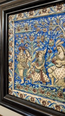 Lot 15 - A large Qajar moulded and underglaze-painted pottery figural tile