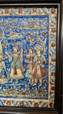 Lot 15 - A large Qajar moulded and underglaze-painted pottery figural tile