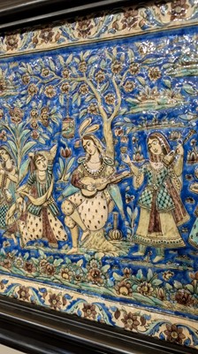 Lot 15 - A large Qajar moulded and underglaze-painted pottery figural tile