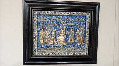 Lot 15 - A large Qajar moulded and underglaze-painted pottery figural tile