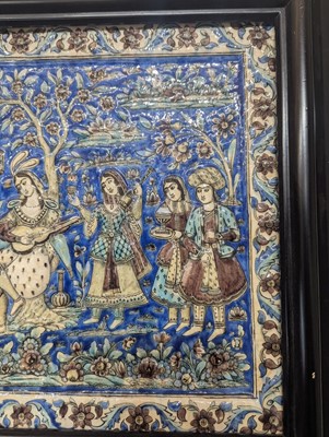 Lot 15 - A large Qajar moulded and underglaze-painted pottery figural tile