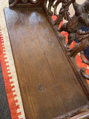 Lot 81 - A Black Forest carved linden wood bench
