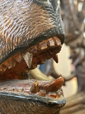 Lot 81 - A Black Forest carved linden wood bench