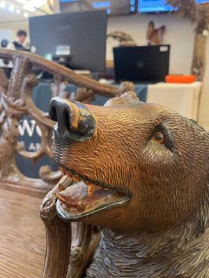 Lot 81 - A Black Forest carved linden wood bench