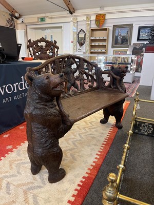 Lot 81 - A Black Forest carved linden wood bench