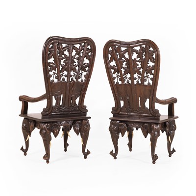 Lot 41 - A pair of carved linden wood Black Forest elbow chairs