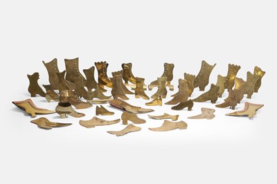 Lot 197 - A collection of brass shoes and boots