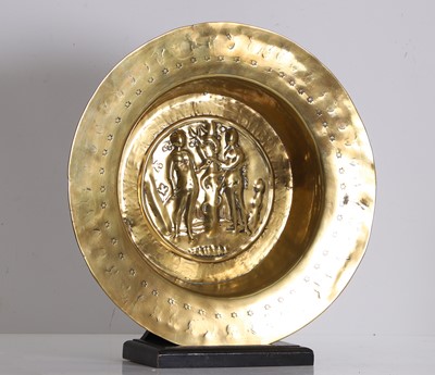 Lot 332 - A brass alms dish with repoussé Adam and Eve medallion