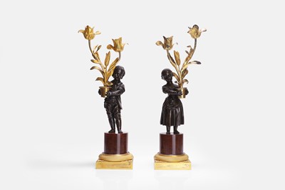 Lot 628 - A pair of Louis XVI patinated and gilt-bronze candelabra