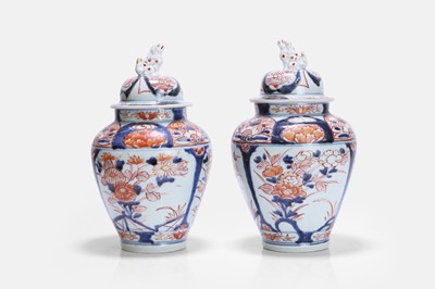 Lot 102 - A pair of Imari porcelain vases and covers
