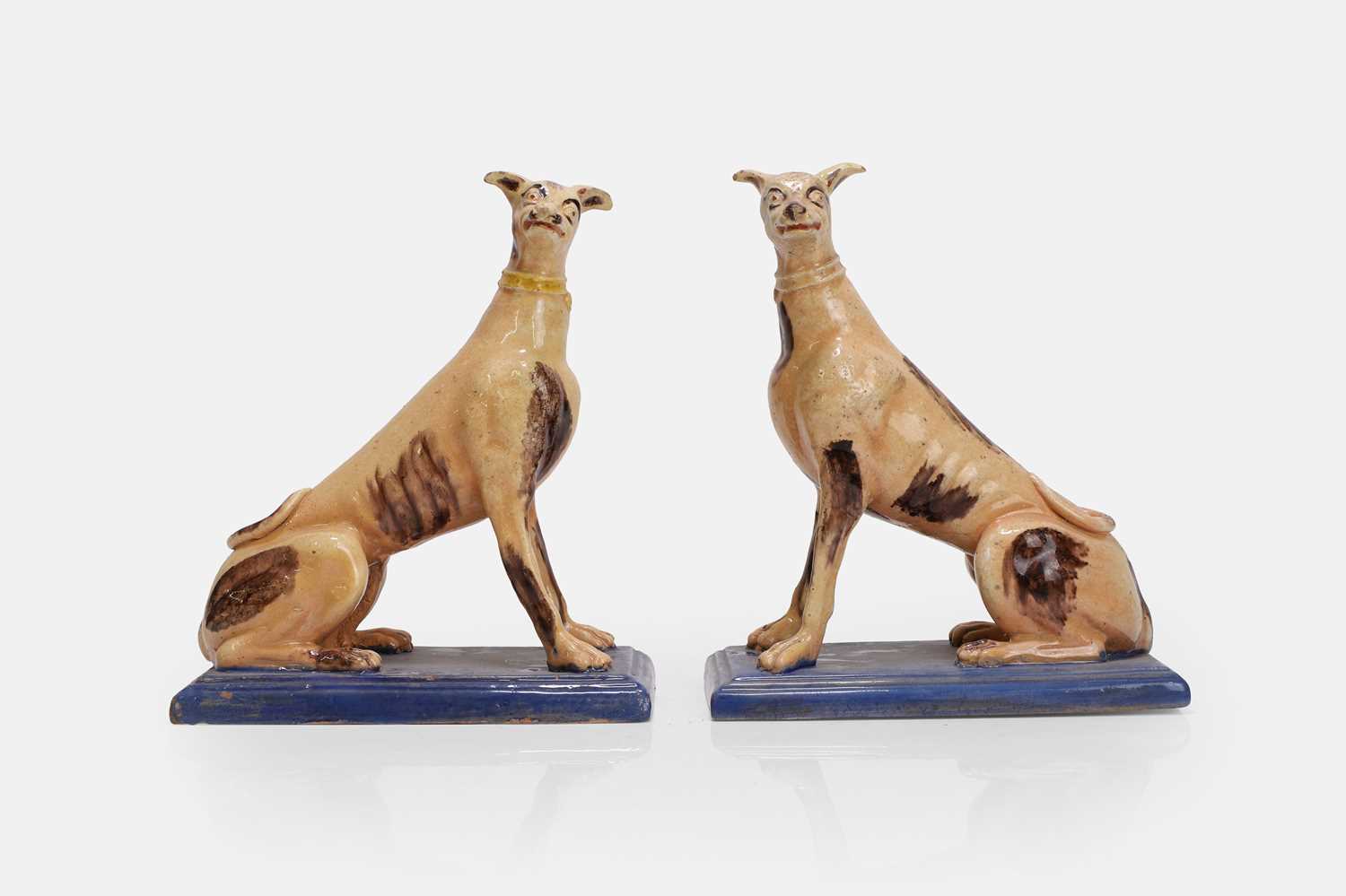 Lot 96 - A pair of faience greyhound figures