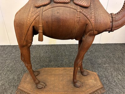 Lot 96 - A pair of teak camel occasional tables