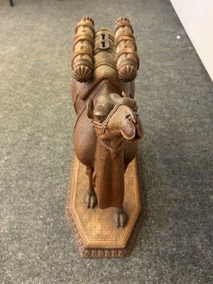 Lot 96 - A pair of teak camel occasional tables