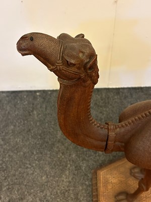 Lot 96 - A pair of teak camel occasional tables