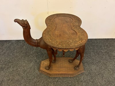 Lot 96 - A pair of teak camel occasional tables