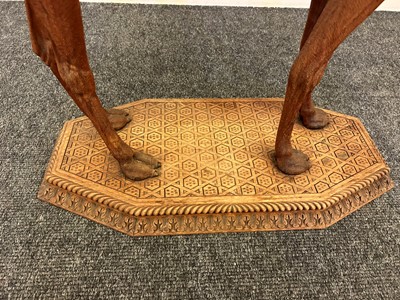 Lot 96 - A pair of teak camel occasional tables