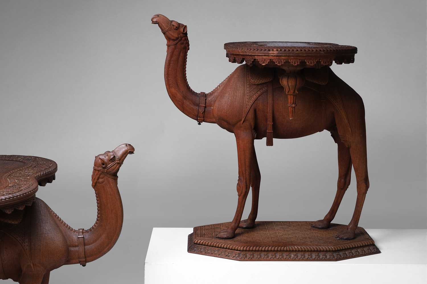 Lot 96 - A pair of teak camel occasional tables
