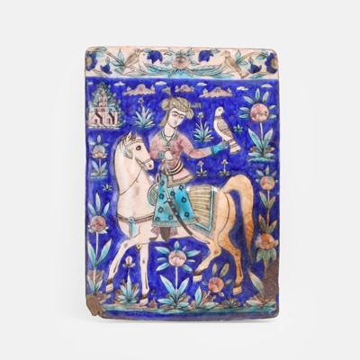 Lot 294 - A Qajar moulded and polychrome painted pottery tile