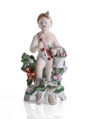 Lot 129 - A Continental porcelain figure of a flower-gathering putto