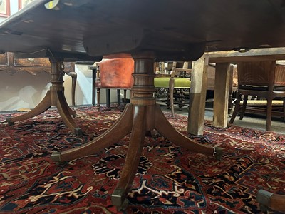 Lot 205 - A George III mahogany three-pillar dining table