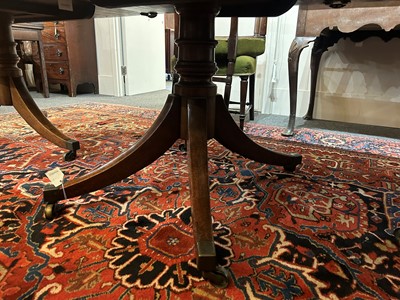 Lot 205 - A George III mahogany three-pillar dining table