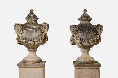 Lot 664 - A pair of composition stone garden urns