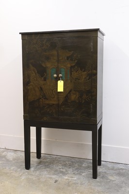 Lot 544 - An OKA japanned cabinet on stand