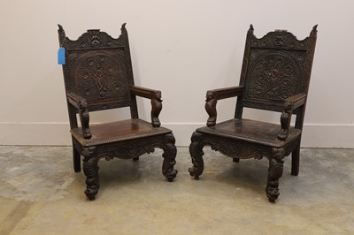 Lot 512 - A pair of carved hardwood armchairs