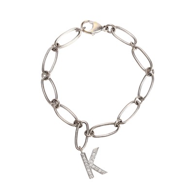 Lot 134 - A white gold bracelet with a diamond set 'K' charm