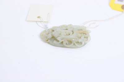 Lot 57 - A Chinese reticulated jade oval plaque
