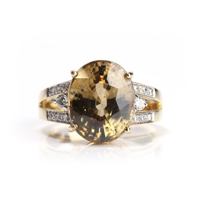 Lot 140 - An 18ct gold yellow zircon and diamond ring
