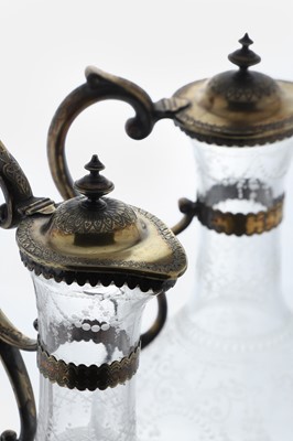 Lot 526 - A pair of Victorian etched glass and silver-gilt-mounted claret jugs