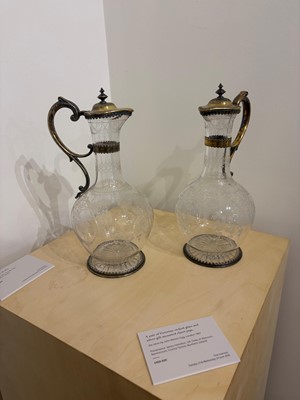 Lot 526 - A pair of Victorian etched glass and silver-gilt-mounted claret jugs