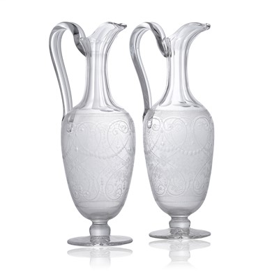 Lot 40 - A pair of engraved glass claret jugs