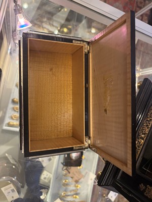 Lot 533 - An Art Deco ebonised and silver-plated cigarette box