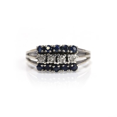 Lot 188 - A white gold sapphire and diamond cluster ring