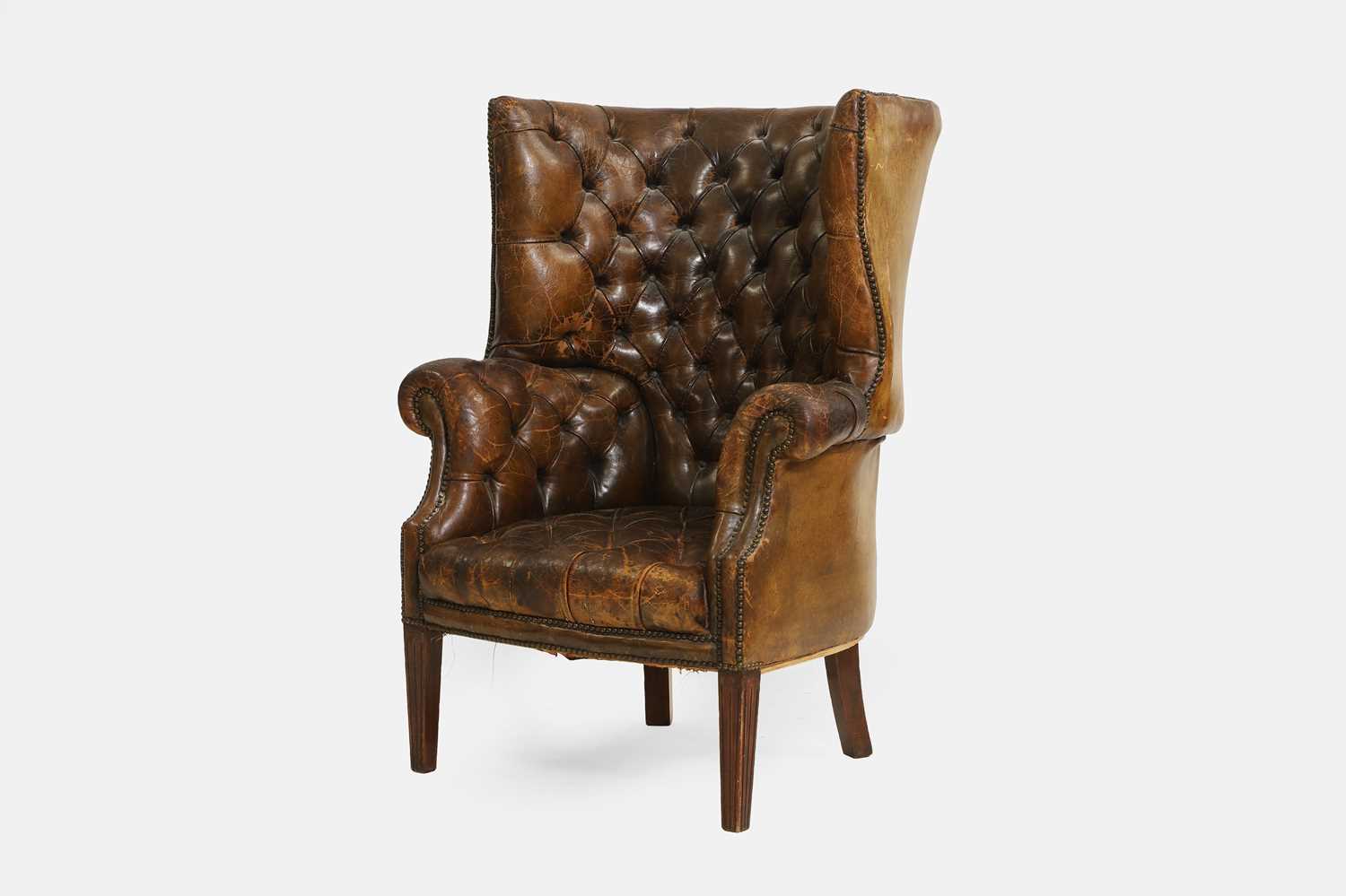 Lot 193 - A George III-style barrel-back leather armchair