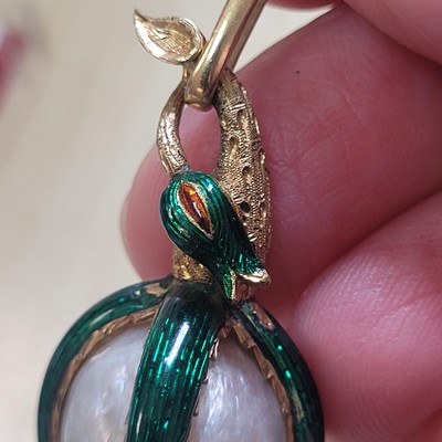 Lot 58 - A mother-of-pearl and enamel locket pendant
