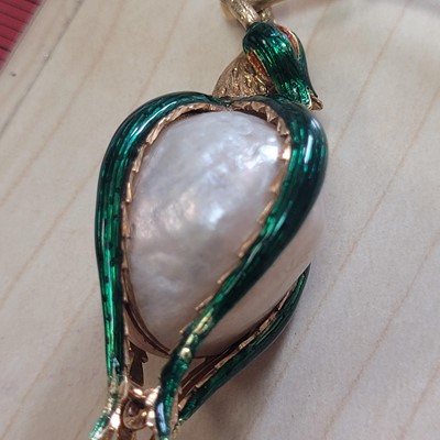 Lot 58 - A mother-of-pearl and enamel locket pendant