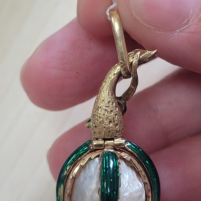 Lot 58 - A mother-of-pearl and enamel locket pendant